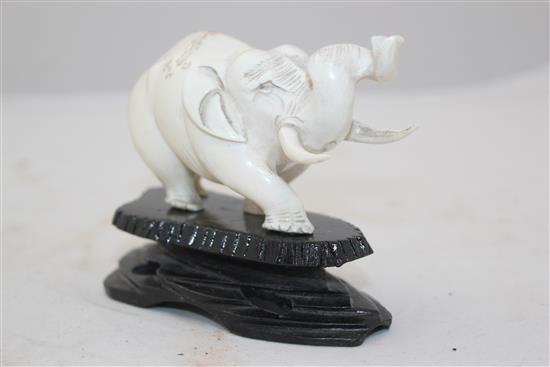 A Chinese ivory figure of an elephant, with wood stand, 1st half 20th century, 19.5cm